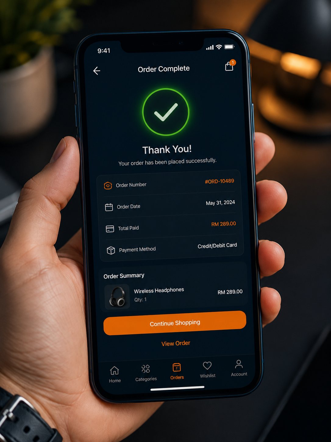 A customer's phone showing a completed RekaCMS order confirmation with order number, order date, total paid and payment method